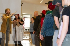 Nutidens Ande (Anki Wede) lär Scrooge hur man leder en riktig julkör (Kören Con Spirito)